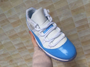 Jordan 11 Low Sneakers in White and University Blue