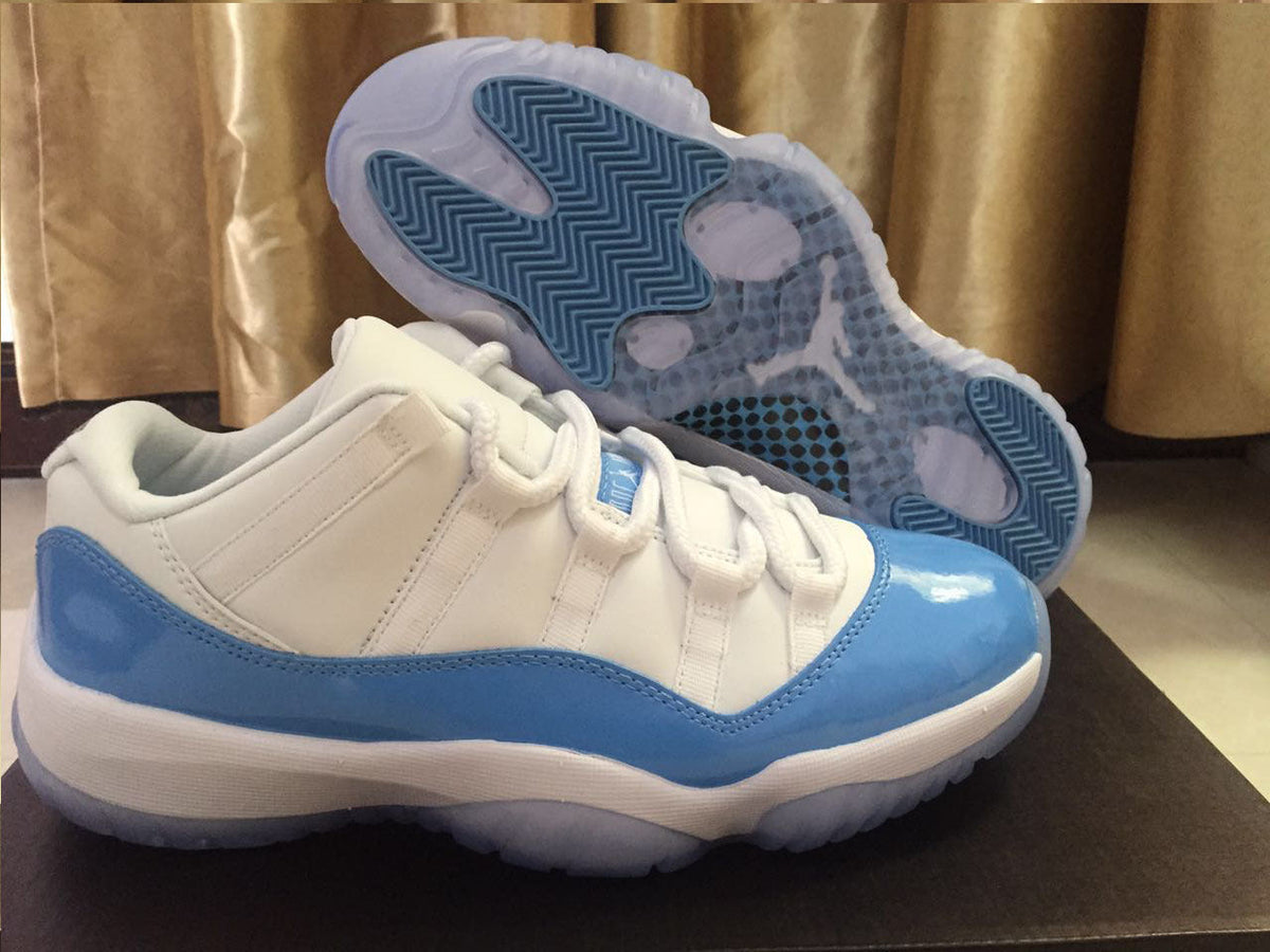 Jordan 11 Low Sneakers in White and University Blue