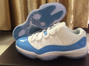 Jordan 11 Low Sneakers in White and University Blue