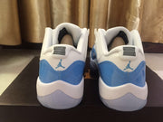 Jordan 11 Low Sneakers in White and University Blue