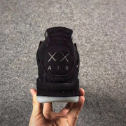 Jordan 4 KAWS Graffiti Black High-Top Sneakers