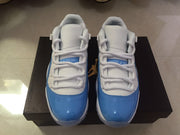 Jordan 11 Low Sneakers in White and University Blue