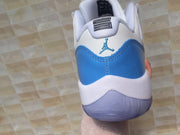 Jordan 11 Low Sneakers in White and University Blue
