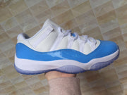 Jordan 11 Low Sneakers in White and University Blue