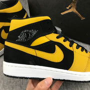 Air Jordan 1 Mid Black and Yellow Sneakers